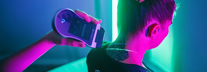 Erchonia Laser Device Being Used On The Back Of A Patient's Neck